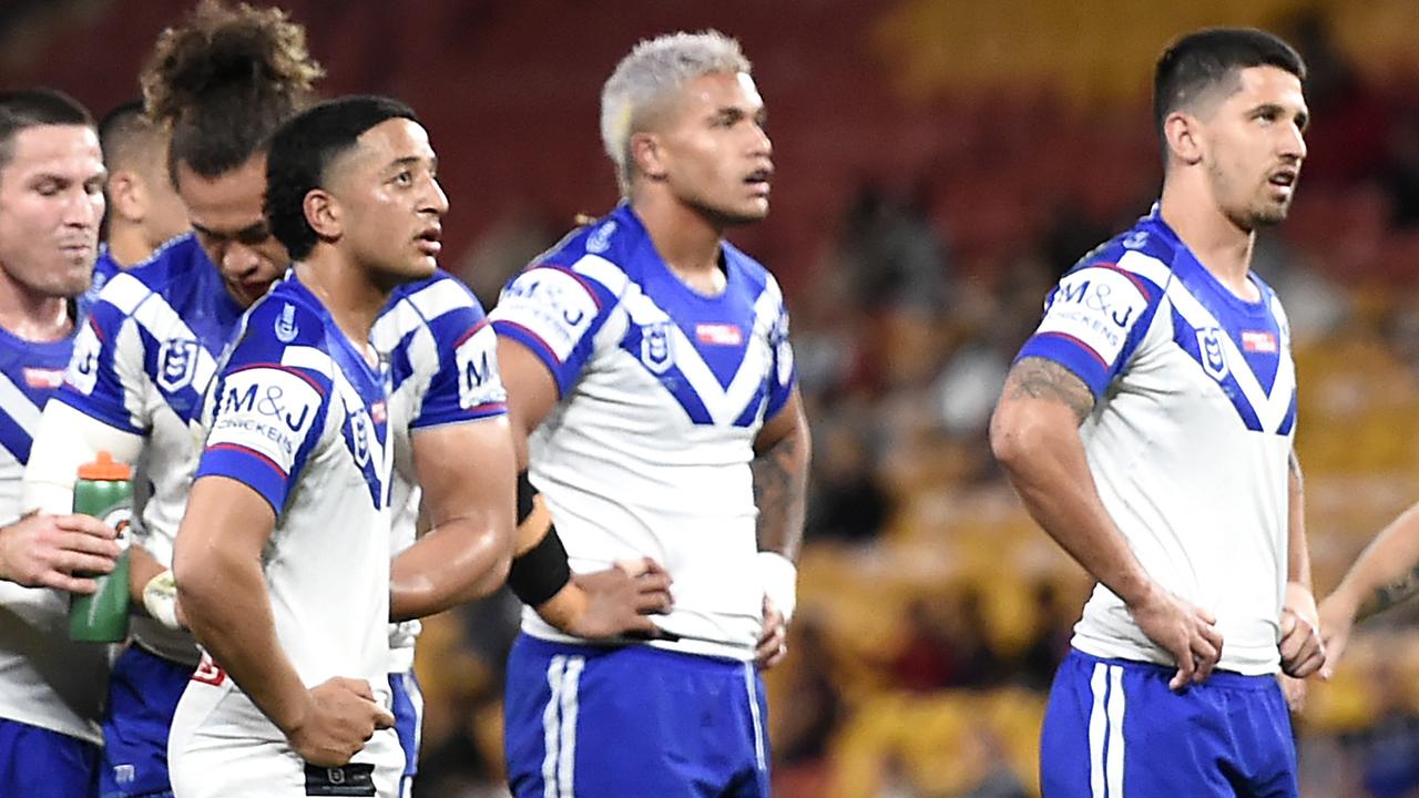 Bulldogs players wait for the result of a video review during their loss to Brisbane.