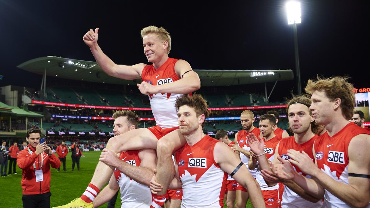 Isaac Heeney is carried off the field after victory to celebrate his 150th game at the Sydney Cricket Ground on August 14, 2022. Photo: Getty Images